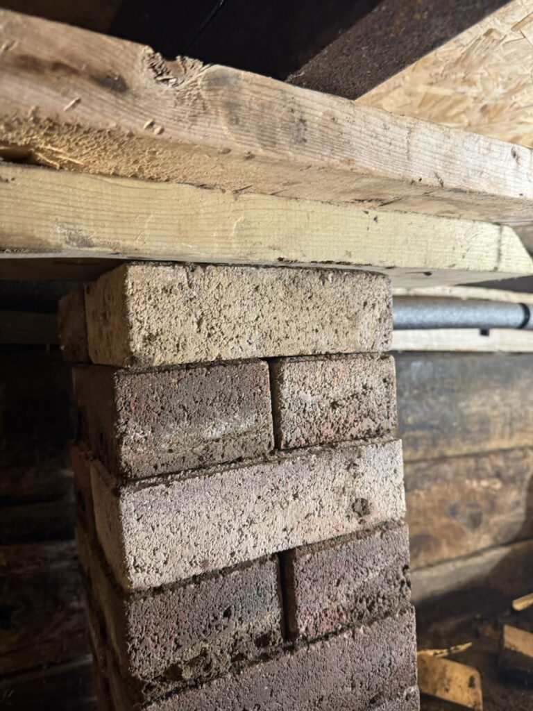 Added shims to piers in the crawl space to level floors