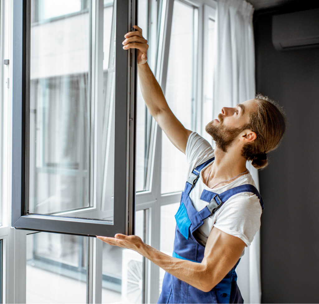 worker adjusting window frames during window installation